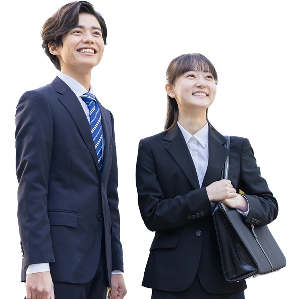 two students in suits smiling